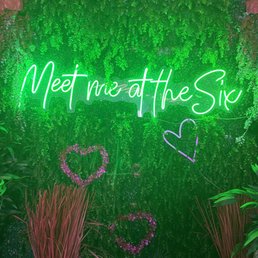 neon sign saying'metime at the six '