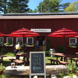 a red barn with tables and umbrellas