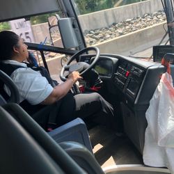 Vamoose Bus - Red arrow shows Rosary beads, Blue arrow shows her cellphone cable/mic. Not SAFE!!