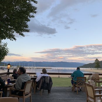 Trinity At City Beach - The view from the outdoor seating area. Normally they have more tables, but this is at 50% capacity due to Covid-19. - American Near Me - Sandpoint, Idaho Trinity At City Beach - The view from the outdoor seating area. Normally they have more tables, but this is at 50% capacity due to Covid-19. - American Near Me - Sandpoint, Idaho