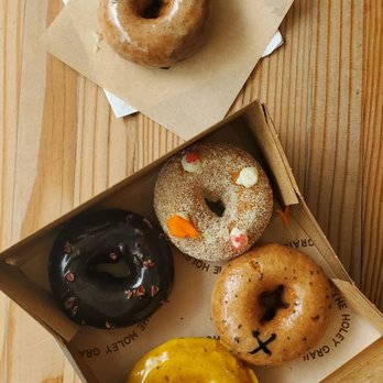 Holey Grail Donuts - og glazed outside the tasting box. starting from the darkest and going clockwise, chocolate crunch, L&L, North shore, miso horny - Donuts Near Me - Honolulu, Hawaii Holey Grail Donuts - og glazed outside the tasting box. starting from the darkest and going clockwise, chocolate crunch, L&L, North shore, miso horny - Donuts Near Me - Honolulu, Hawaii