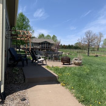 Crescent Moon Winery - a patio with lounge chairs and a fire pit - Wineries Near Me - Lawrence, Kansas