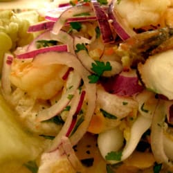 Costa Verde - Ceviche Mixto topped with Crispy Red Onions, accompanied by Peruvian large-grain Corn and Yuca.