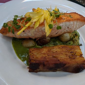Bistro Campagne - Salmon with fava beans pearl onions potato, chili oil and chervil cream - French Near Me - Chicago, Illinois Bistro Campagne - Salmon with fava beans pearl onions potato, chili oil and chervil cream - French Near Me - Chicago, Illinois