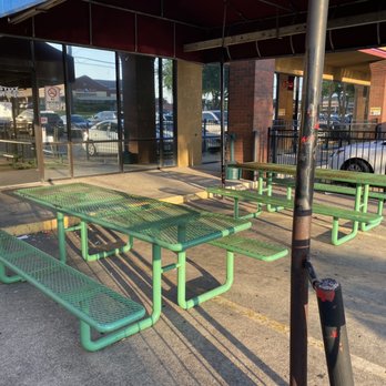 Stixx and Stones Billiards - a row of green picnic tables - Sports Bars Near Me - Lewisville, Texas