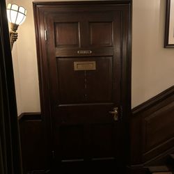 Simpson's in the Strand - Puzzled why there is a letterbox in the door to the Gents...