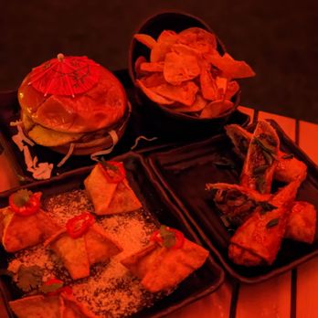 Zanzibar - Kahuna Burger, pork wontons, and duck egg rolls - Tiki Bars Near Me - Austin, Texas Zanzibar - Kahuna Burger, pork wontons, and duck egg rolls - Tiki Bars Near Me - Austin, Texas
