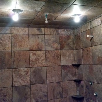 Erk Flooring - a bathroom with a tiled shower - Flooring Near Me