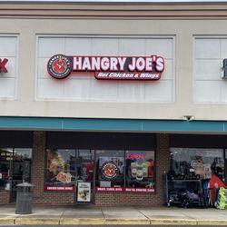 Just right of the center of the strip mall, between a Chinese take-out and a used-sporting-goods store