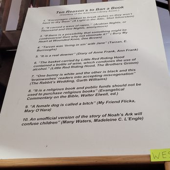 A Book Barn - A whiteboard in a bookstore displays ten humorous reasons to ban a book, referencing various literary and cultural quotes. - Bookstores Near Me - Clovis, California