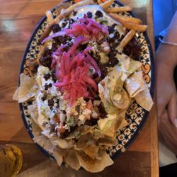 Mis Tacones - Half fries, half chips El Pastor nachos. Spicy and delicious!
