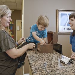 Georgia Chiropractic Care - A pediatric patient picking an item from the treasure chest.
