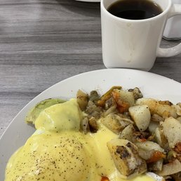 Eggs Benedict with Bacon and Avocado and a side of home fried potatoes Eggs Benedict with Bacon and Avocado and a side of home fried potatoes