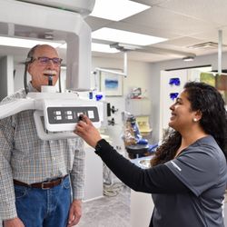 Singla Dental - Assistant using a Conebeam for a more in depth look at a patients smile and jaw at Singla Dental in Duncanville, TX