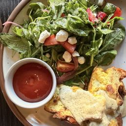 Strata with a rosemary mornay sauce + vinaigrette-dressed salad. A standard-issue ketchup was provided for the potatoes (not pictured). Strata with a rosemary mornay sauce + vinaigrette-dressed salad. A standard-issue ketchup was provided for the potatoes (not pictured).