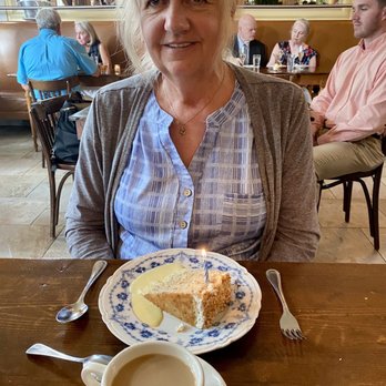 Chez Fonfon - Coconut pecan cake with a candle for her birthday - French Near Me - Birmingham, Alabama Chez Fonfon - Coconut pecan cake with a candle for her birthday - French Near Me - Birmingham, Alabama