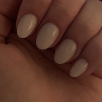 Avalon Nails - Nails by Dylan - The image displays a close-up of a hand with five fingers, each with neatly manicured nails painted in a light, neutral color with a glossy finish. The background is blurred, suggesting an indoor environment, possibly a salon or home setting. The focus is on the nails and the skin of the hand, which appears smooth and well cared for. - Nail Salons Near Me - Glendale, Arizona