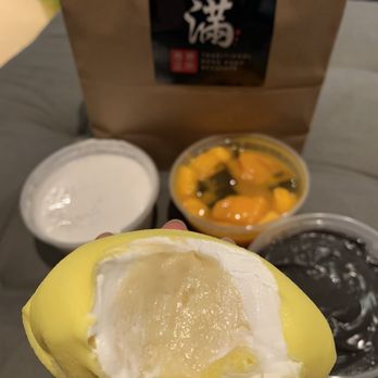Full House Desserts - a person holding a half eaten banana - Desserts Near Me - Richmond Hill, Ontario Full House Desserts - a person holding a half eaten banana - Desserts Near Me - Richmond Hill, Ontario