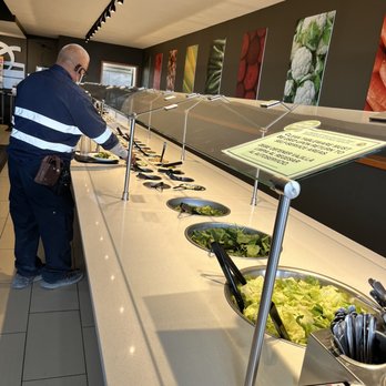 Souper Salad - a man standing in front of a buffet - Salad Near Me - El Paso, Texas