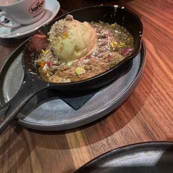 Umbria - Skillet cookie. It has edible flowers on it and served with vanilla gelato - Italian Near Me - Boston, Massachusetts