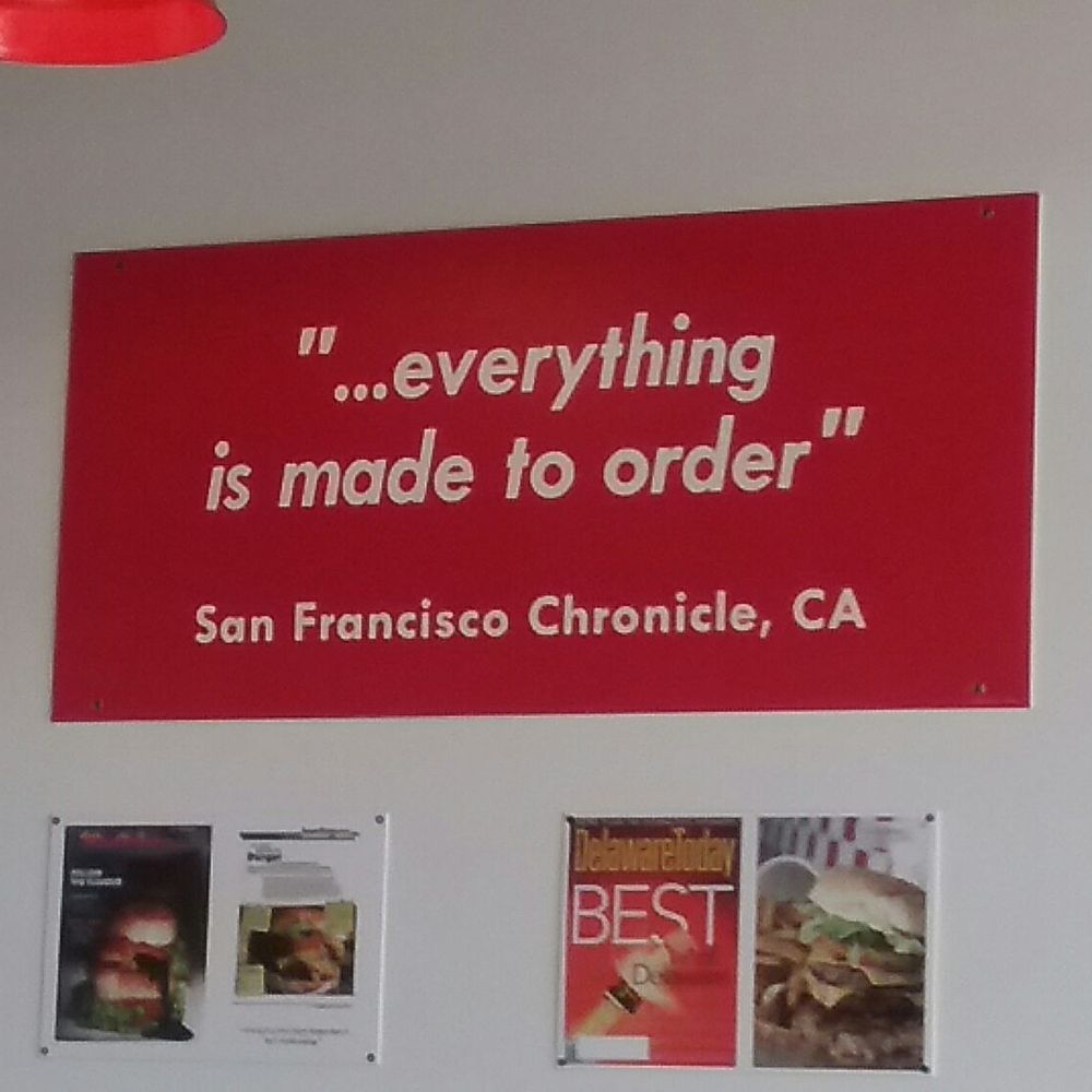 Five Guys - a red sign hanging on a wall - Fast Food Near Me - Yakima, Washington Five Guys - a red sign hanging on a wall - Fast Food Near Me - Yakima, Washington