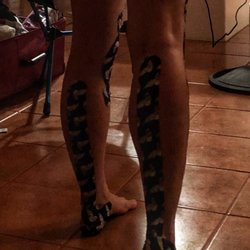High Performance Therapy - Scraping Achilles tendon and calves to break dow myofascial, finishing up with Kenesiotape to protect and stabilize it for a 26 miles hike.