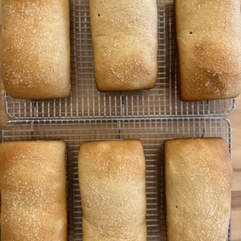H Wyatt - four loafs of bread on a cooling rack - Bakeries Near Me - Bishop Hill, Illinois H Wyatt - four loafs of bread on a cooling rack - Bakeries Near Me - Bishop Hill, Illinois