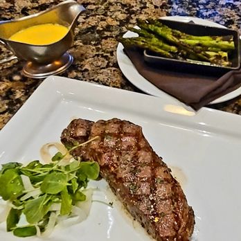 Farraddays Steakhouse - 16oz NY strip, med rare with a side of asparagus with hollandaise sauce - Steakhouses Near Me - Pompano Beach, Florida Farraddays Steakhouse - 16oz NY strip, med rare with a side of asparagus with hollandaise sauce - Steakhouses Near Me - Pompano Beach, Florida