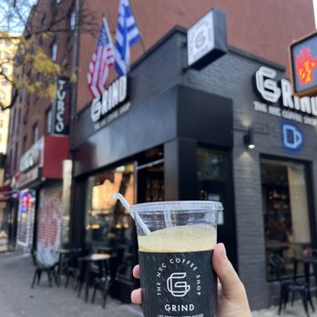 Grind NYC - Coffee cup with Grind in the background - Cafes Near Me - New York, New York Grind NYC - Coffee cup with Grind in the background - Cafes Near Me - New York, New York