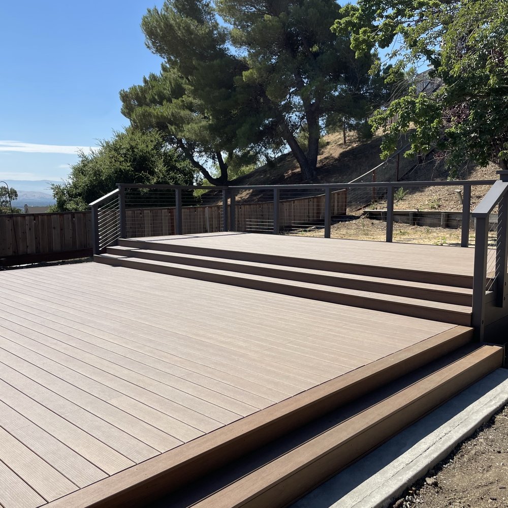 New composite deck with painted redwood and steel cable railing New composite deck with painted redwood and steel cable railing