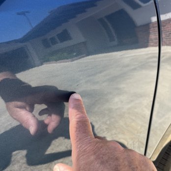 Diaz Paintless Dent Repair - AFTER : no dent and you can only see a small spot above my finger which is the touch up paint to cover the chip - Mobile Dent Repair Near Me Diaz Paintless Dent Repair - AFTER : no dent and you can only see a small spot above my finger which is the touch up paint to cover the chip - Mobile Dent Repair Near Me