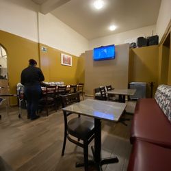 Mona Liza - View of dining room with new reggaeton songs playing on the tv