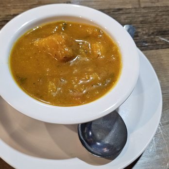 Bullfish Bistro - Butternut Soup Joumou Hearty and comforting pureed squash, root vegetables, turnips and greens in a rich broth - Caribbean Near Me - Baton Rouge, Louisiana