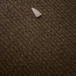 a paper airplane on the floor a paper airplane on the floor