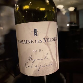 Vin Sur Vingt - a bottle of wine on a table - Wine Bars Near Me - Washington, DC, District of Columbia