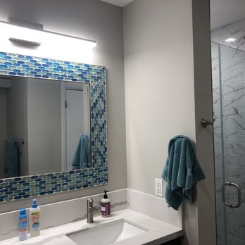 Handyman Construction - They designed and made this custom mirror frame to match their tile work in the new shower - General Contractors Near Me Handyman Construction - They designed and made this custom mirror frame to match their tile work in the new shower - General Contractors Near Me