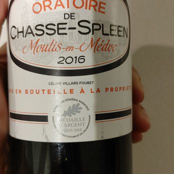 The Wine Merchant - a hand holding a bottle of wine - Beer, Wine & Spirits Near Me - Olivette, Missouri