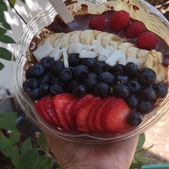 Fruity Smoothie & Granola - a hand holding a bowl of fruit - Juice Bars & Smoothies Near Me Fruity Smoothie & Granola - a hand holding a bowl of fruit - Juice Bars & Smoothies Near Me