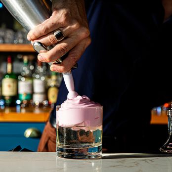 AZUR - a bartender mixing a drink at a bar - Tapas/Small Plates Near Me - Charleston, South Carolina