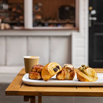 R.Mora Photography - Variety of croissants served outdoors on a table in front of cafe window. - Session Photography Near Me - Los Angeles, California R.Mora Photography - Variety of croissants served outdoors on a table in front of cafe window. - Session Photography Near Me - Los Angeles, California