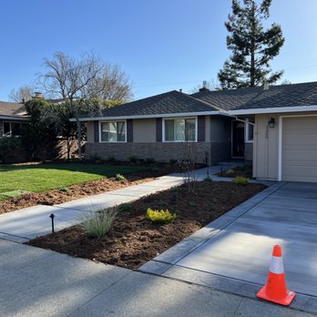 Primo Landscape + Design - the front of a house with a driveway and a driveway cone in the foreground - Landscaping Near Me - Sacramento, California