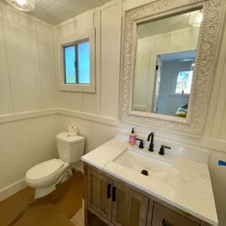 Fast Masters - Handyman and Plumbing - Completely overhauled bathroom... Added wainscoting, installed new vanity, flooring, light fixtures and door hardware.
