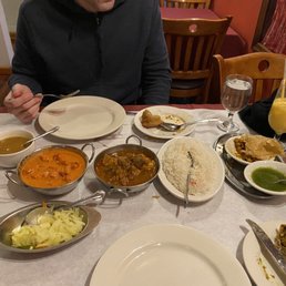 Chicken tikka masala, chicken vindaloo, samosas, chana masala, and mango lassi