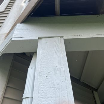 Elite Exteriors - Another great cut. - A painted wooden support beam and part of a balcony structure are shown, with visible wood grain and construction details. - Roofing Near Me - New Berlin, Wisconsin