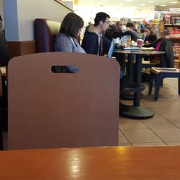 two people sitting at a table in a coffee shop two people sitting at a table in a coffee shop