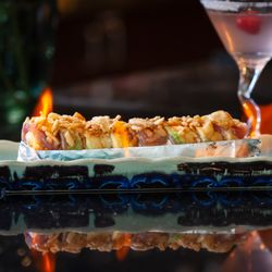 Wasabi Sushi Bar - SUPER SAIYAN
Crab mix, cream cheese, shrimp tempura, topped with tuna, avocado, spicy omega sauce, crispy fried onions.