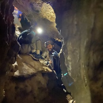 Moaning Caverns Adventure Park - Tyler helping us through the tunnel - Amusement Parks Near Me - Vallecito, California