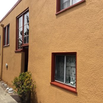Two Sons Handymen - Right side of duplex, with rebuilt windows above doorway in the middle. - Flooring Near Me