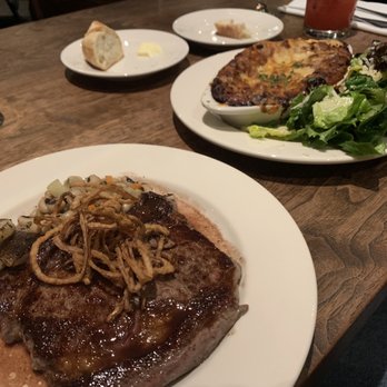 Oswald - Ribeye steak with crispy onions, split black eye peas and turnip with a wine reduction sauce. - New American Near Me - Santa Cruz, California Oswald - Ribeye steak with crispy onions, split black eye peas and turnip with a wine reduction sauce. - New American Near Me - Santa Cruz, California