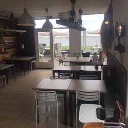 't Mootje - Inside the restaurant with Lauwersmeer lake and outdoor seating in the background.